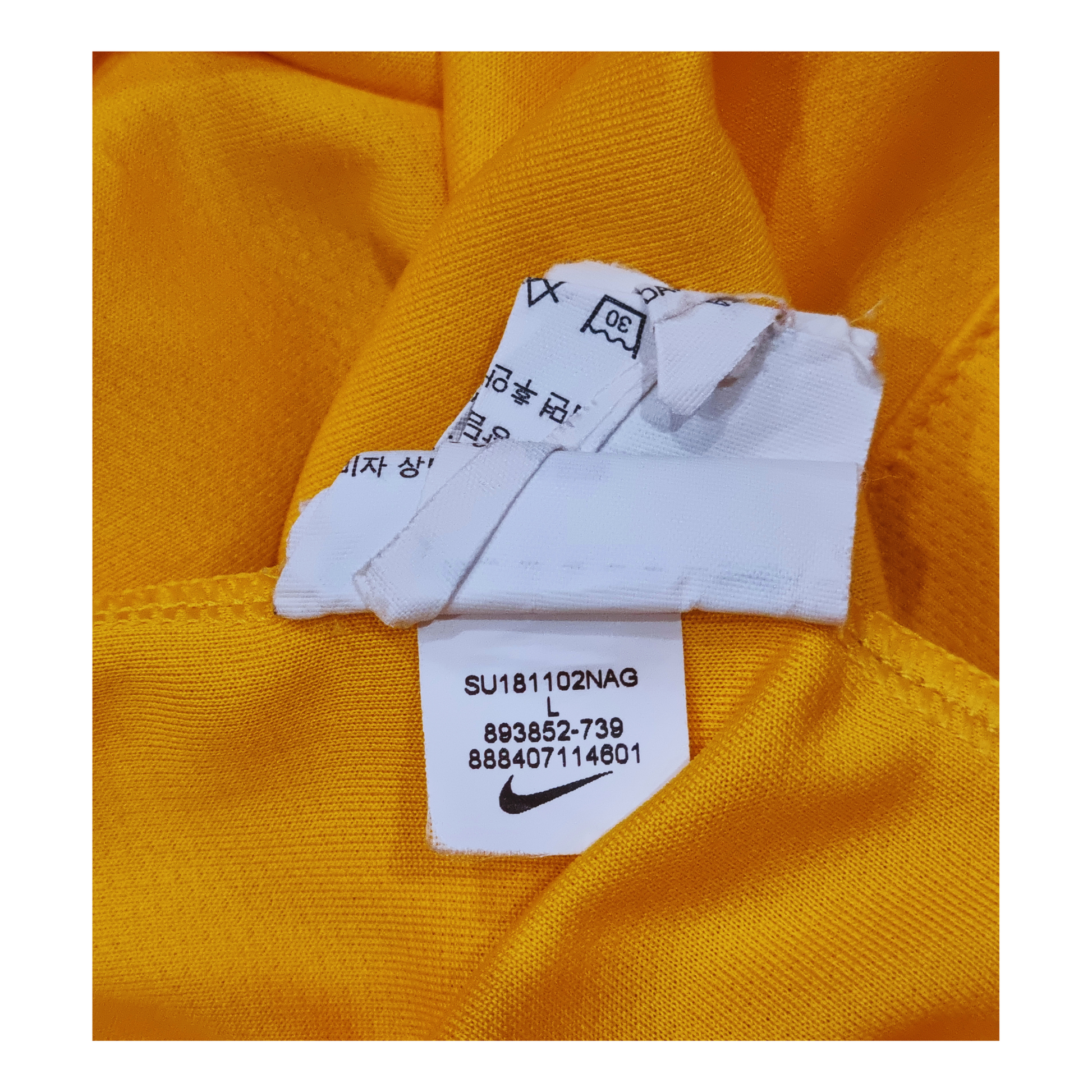 A yellow Australia Nike Australia 2018 Home Jersey with a label on it.