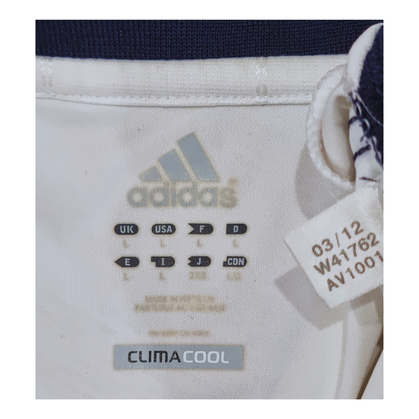 A pair of Adidas pants with a Real Madrid 2012/13 Home Jersey label on them.